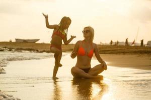 mother and daughter happy in love at sunset photo