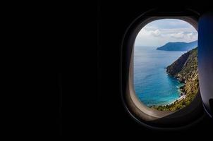 Italy looking out an airplanes porthole window during a flight , image using for sky and interior airplane concept photo