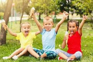 Group of happy little friends having fun at the yard. photo