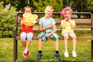 Three happy children playing in the park at the day time. Concept Brother And Sister Together Forever photo