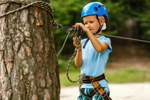 Active children's recreation. Climbing the rope park photo