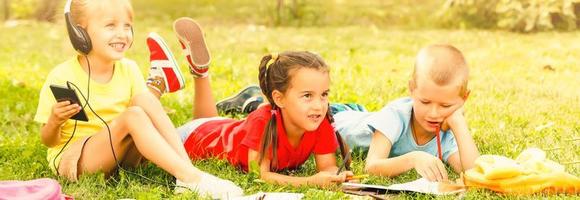 Happy interracial group of kids playing in summer photo