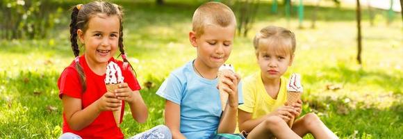 funny children group kidding with ice cream on party photo