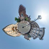 Little planet and spherical aerial 360 panorama view on street ancient medieval city with church and historic buildings photo