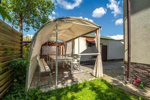 interior of hall veranda or gazebo in wooden village vacation home with garden chairs photo