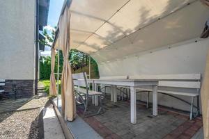 interior of hall veranda or gazebo in wooden village vacation home with garden chairs photo