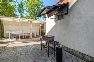 interior of hall veranda or gazebo in wooden village vacation home with garden chairs photo