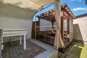 interior of hall veranda or gazebo in wooden village vacation home with garden chairs photo