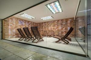 interior of modern wellness salt haloper cave with uv light with wooden bench photo