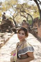 beautiful asian woman smiling with happiness face standing in old temple at ayutthaya heritage site of unesco thailand photo