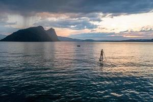 A paddler on a lake during the sunset photo