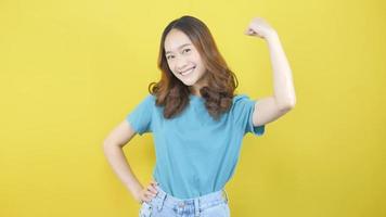 An active lifestyle concept for slim and strong Asians. show muscle The biceps tensed and looked proud. yellow background video