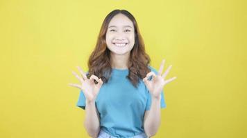 Smiling Asian woman showing OK sign Happy and satisfied standing video