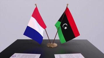 Libya and France national flags on table in diplomatic conference room. Politics deal agreement video