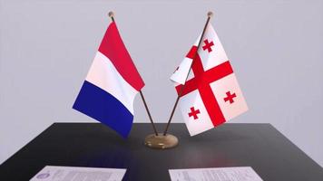 georgien och Frankrike nationell flaggor på tabell i diplomatisk konferens rum. politik handla avtal video