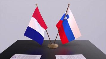 Slovenia and France national flags on table in diplomatic conference room. Politics deal agreement video