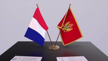 Montenegro and France national flags on table in diplomatic conference room. Politics deal agreement video