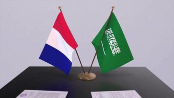 Saudi Arabia and France national flags on table in diplomatic conference room. Politics deal agreement video