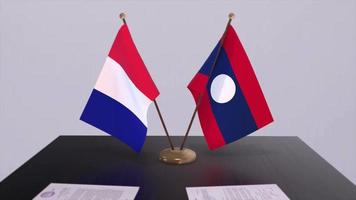 Laos and France national flags on table in diplomatic conference room. Politics deal agreement video