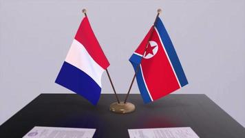 Norden Korea und Frankreich National Flaggen auf Tabelle im diplomatisch Konferenz Zimmer. Politik Deal Zustimmung