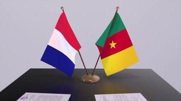 Cameroon and France national flags on table in diplomatic conference room. Politics deal agreement video