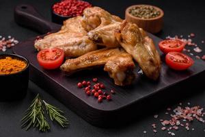 Baked chicken wings with salt, spices and herbs photo