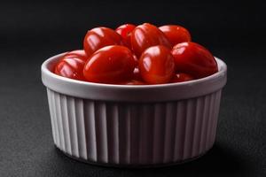 Fresh tasty cherry tomatoes in a white ribbed bowl photo