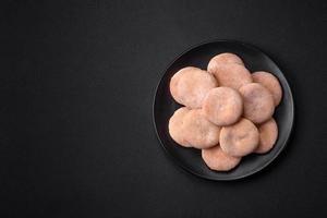 Delicious fresh baked cornmeal shortcakes or cookies on a black plate photo