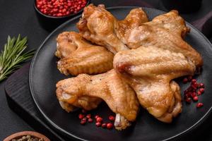 Baked chicken wings with salt, spices and herbs photo