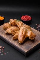 Baked chicken wings with salt, spices and herbs photo