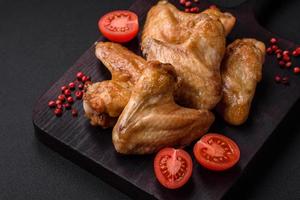 Baked chicken wings with salt, spices and herbs photo