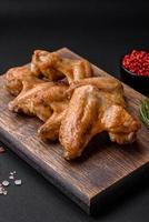 Baked chicken wings with salt, spices and herbs photo