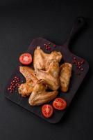 Baked chicken wings with salt, spices and herbs photo