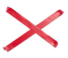 Red sticky tape criss-cross on a white isolated background photo