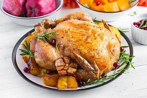 Roasted turkey garnished with cranberries on a rustic style table decorated  autumn leaf. Thanksgiving Day. Baked chicken. photo