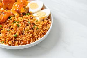 Korean instant noodles with Korean rice cake and fish cake and boiled egg photo