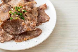 grilled pork neck sliced on plate photo