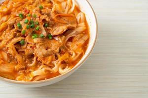 Korean udon ramen noodles with pork in kimchi soup photo