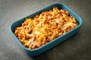 homemade macaroni bolognese with cheese photo