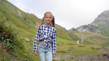 Young girl poses before scenic mountain view video