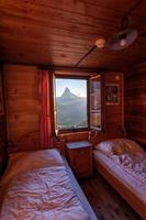 A mountain landscape photographed from a house, the window forms the frame of the image photo