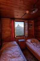 A mountain landscape photographed from a house, the window forms the frame of the image photo