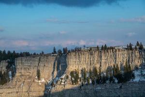 A high cliff in winter during the sunset photo