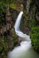 A built hiking trail leading to a waterfall photo