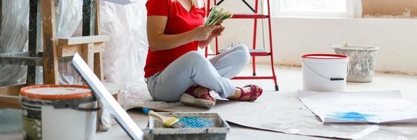 Happy woman paint wall at home. photo