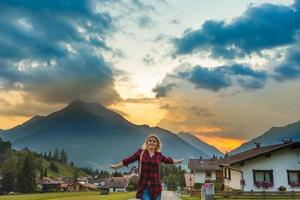 Young beautiful woman traveler , mountains Alps background, photo