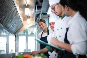 Portrait of a group of chefs and culinary students in the culinary Institute's kitchen. photo