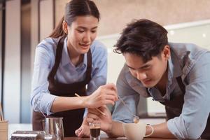 Before competing in the championship level coffee brewing competition, both of the baristas practice their coffee latte makeup techniques to become proficient. photo