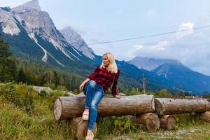 Young beautiful woman traveler , mountains Alps background, photo