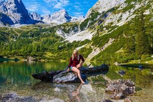 Young beautiful woman traveler , mountains Alps background, photo